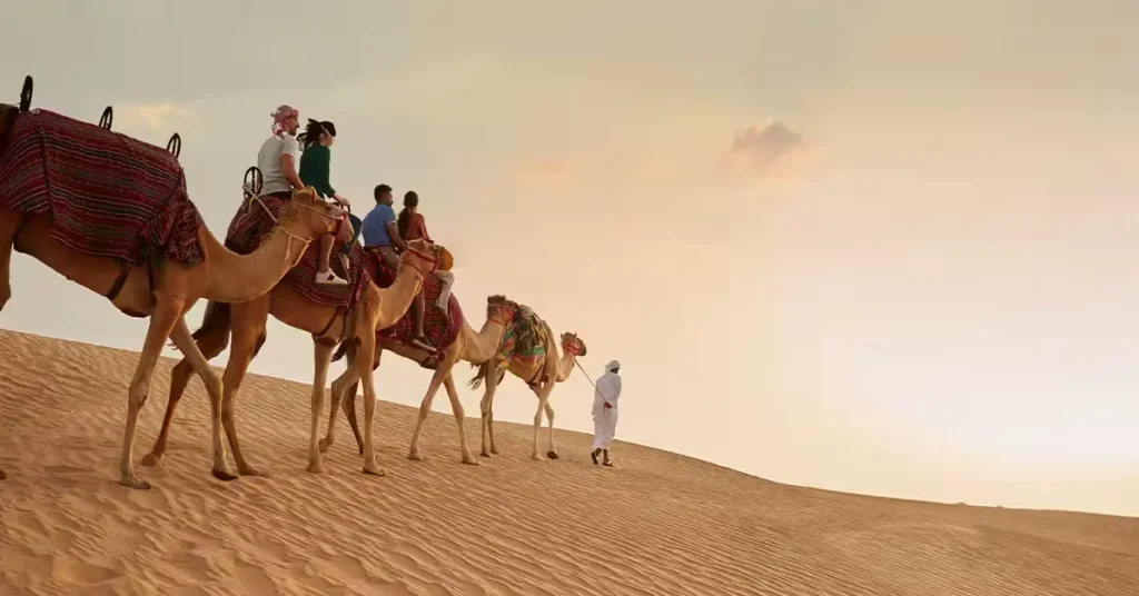 Desert Safari Dubai in Summer with red dunes, sunset, camel rides, and summer adventure
